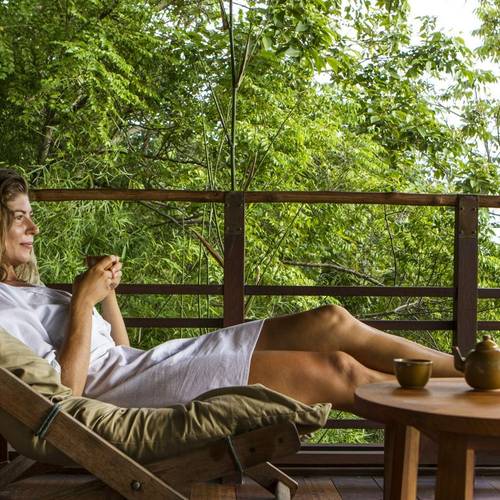 Woman sitting down and relaxing, looking at views on a Winter Wellness retreat